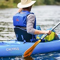 A paddler wearing the Palm Meander Highback PFD Buoyancy Aid on a sit on top kayak
