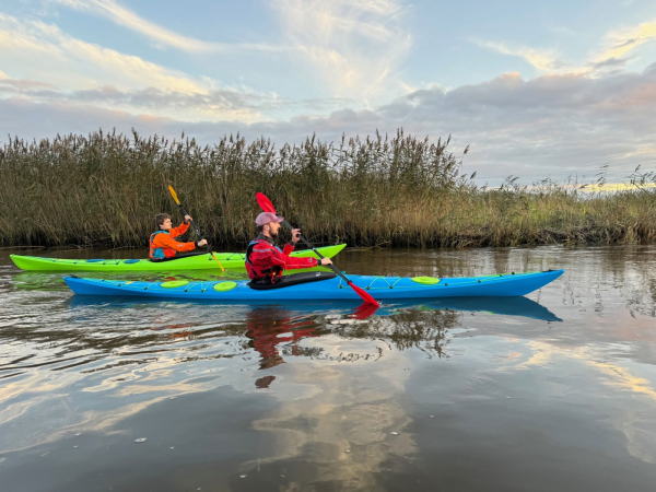 Paddling the Design Kayaks Unplugged sea kayak on calm waters