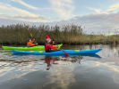 Paddling the Design Kayaks Unplugged sea kayak on calm waters