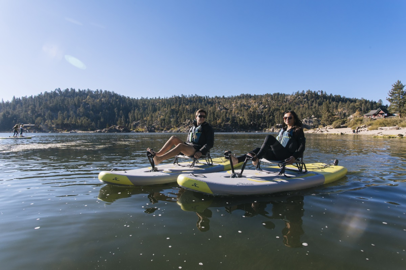 Two people using Hobie Mirage iTrek 9 Ultralight inflatable kayaks