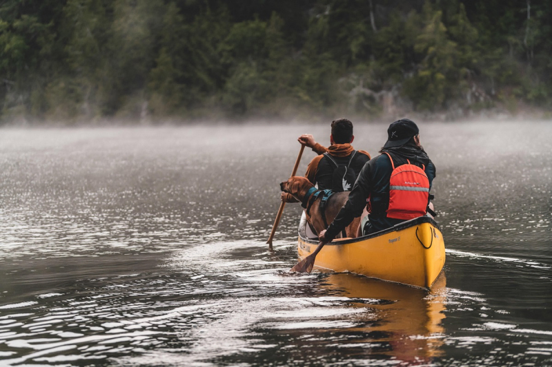 Nova Craft Prospector 15 SP3 Canoe with two people and a dog on a lake