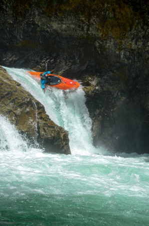 A paddler dropping down a whitewater fall in the Pyranha Scorch X kayak