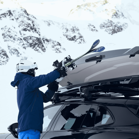 Thule Vector Alpine Roof Box being used to transport skis