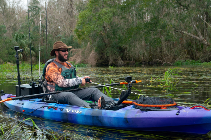Fishing on a lake from the Vibe Sea Ghost 130 kayak