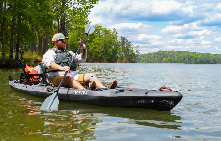 An angler fishing from the Vibe Sea Ghost 130 kayak