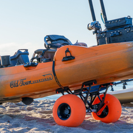A fishing kayak loaded onto the Yak Attack TowNStow Bunkster Cart with Sand Tires