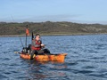 An angler fishing from the Feelfree Moken 12.5 PDL in Cornwall on the sea